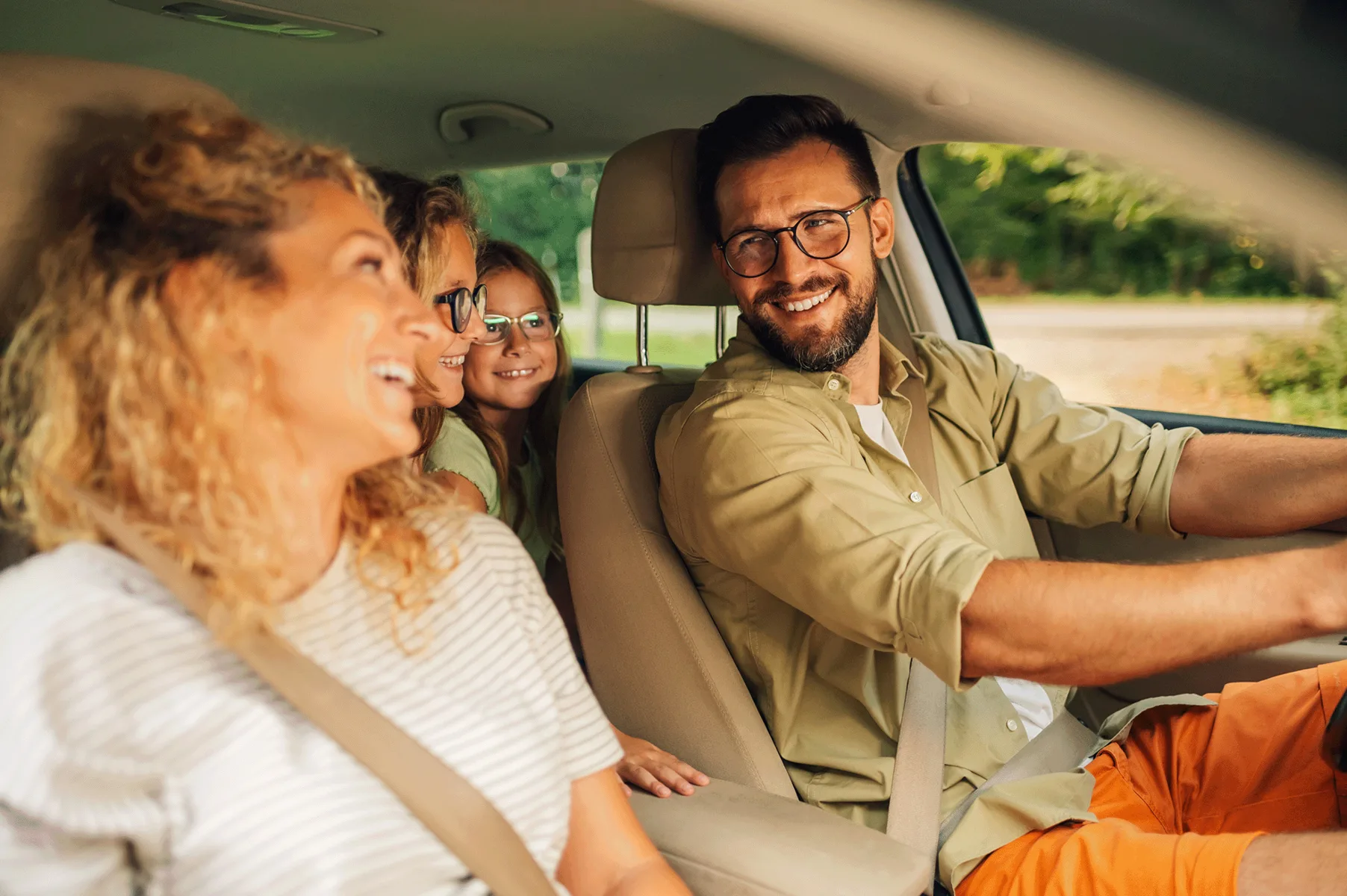 Happy family enjoying a ride in their clean car